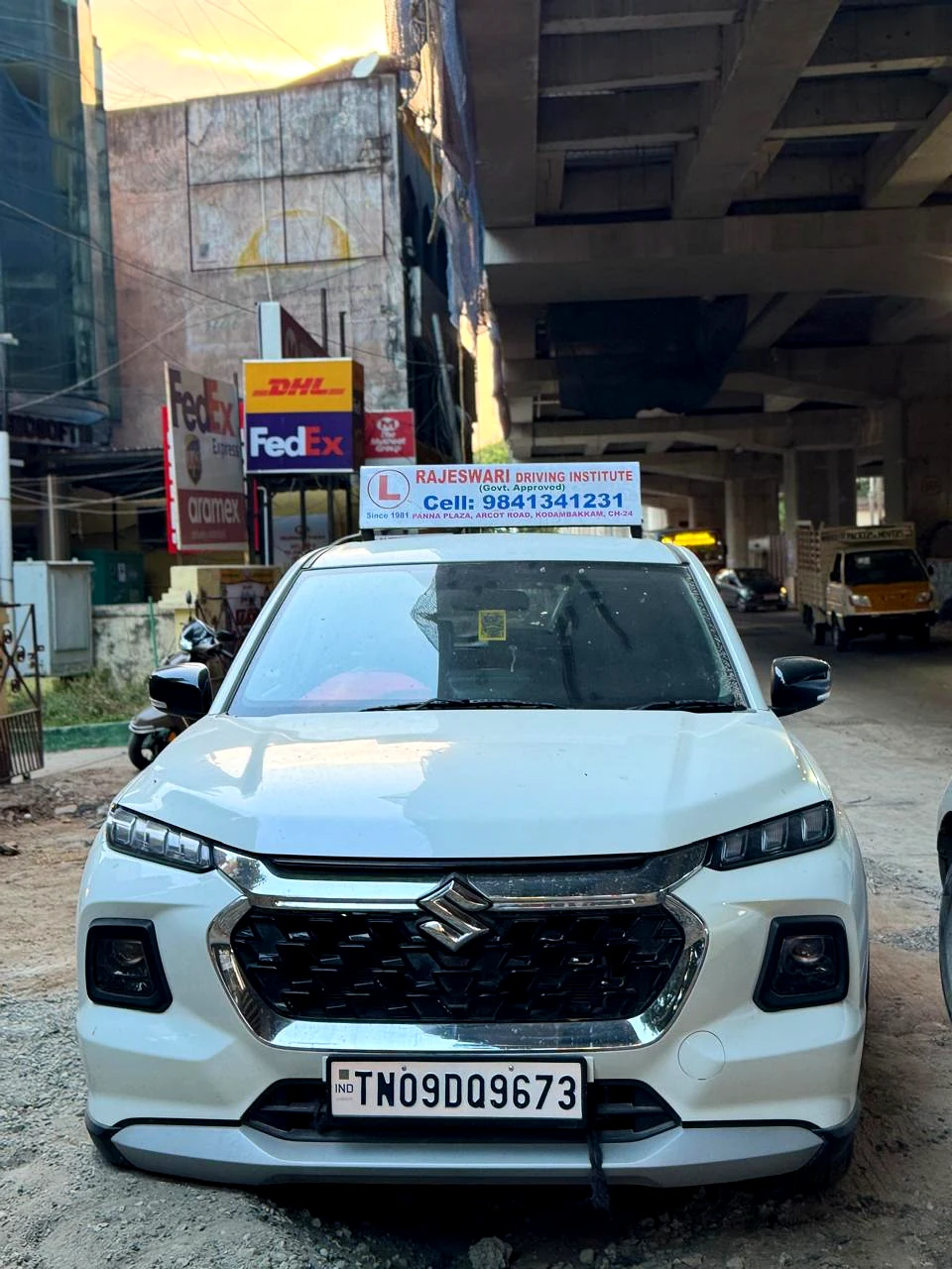 White Suzuki SUV training car with Rajeswari Driving Institute sign