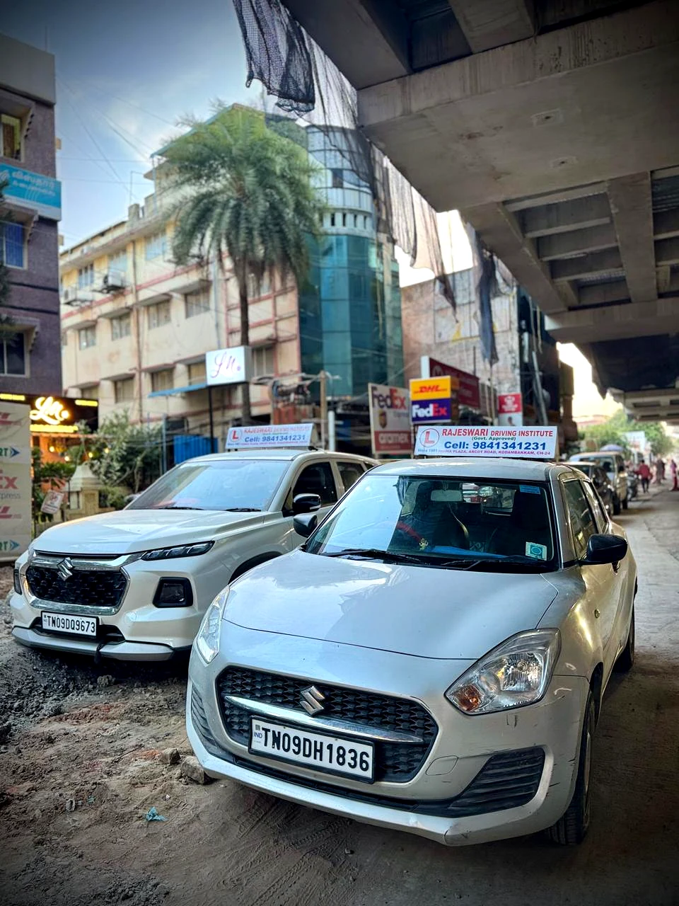 Two Rajeswari Driving Institute cars parked together